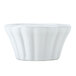 A close up of a Hall China bright white flared ramekin with a wavy edge.