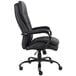 A black Boss office chair with arms and wheels.