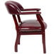 A burgundy vinyl Boss Captain's Chair with gold studs.