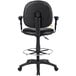 A Boss black drafting stool with a round metal base and adjustable arms and footring.