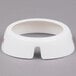 A white circular plastic collar with maroon text.