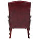 A Boss burgundy leather wingback guest chair with a backrest.