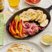 A skillet with chicken, peppers, and onions cooked with Regal Southwestern Blend.