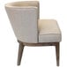 A beige Boss Ava accent chair with wooden legs and frame and a cushion.