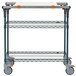 A three tiered metal Metro PrepMate MultiStation cart with wheels.