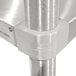 A close-up of a stainless steel corner pole on an Advance Tabco stainless steel equipment stand.