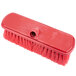 A red Carlisle Sparta brush with a hole in the handle.