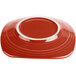 A red Fiesta® luncheon plate with a white rim.