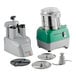 A combination food processor set with a stainless steel bowl, continuous feed attachment, and multiple discs and blades.