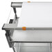 a white cutting board on a metal shelf