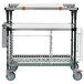 A Metro stainless steel cart with SuperErecta Pro shelving and wheels with two trays on the shelves.