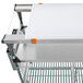 A Metro stainless steel cart with a white cutting board on top.