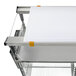 A white cutting board on a Metro metal shelf with orange handles.