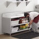 A man in a white shirt using a Regency stainless steel enclosed base work table in a professional kitchen.