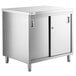 A Regency stainless steel enclosed base table with sliding doors.