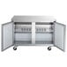 An Avantco stainless steel undercounter freezer with two doors open.