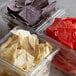 A plastic container of Mission 4-Cut Tri-Color Tortilla Chips.