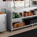 A stainless steel dish cabinet with an adjustable midshelf, used for kitchen storage and organization.