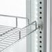 A metal shelf in a white Avantco refrigerated display case.