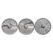 A group of circular metal Hobart food processor slicing plates with holes in them.