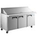 An Avantco stainless steel 3 door refrigerated sandwich prep table on wheels.