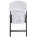 The back of a white Lifetime Light Duty folding chair with black legs.