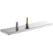 A Regency stainless steel surface mount beer drip tray with rinser on a bar counter.