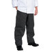 A person wearing Chef Revival black and white pinstripe chef pants.