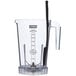 A clear plastic Waring blender with a black handle.