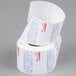 A Globe E12 label roll with red and white labels on a roll of paper.