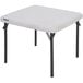 A white square table with black legs.