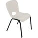 A white plastic Lifetime children's stacking chair with black legs.