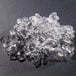 A pile of flake ice made by a Hoshizaki water cooled ice machine on a black surface.