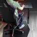 A man sitting in a chair on a black ES Robbins chair mat using a computer.