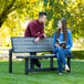 A man and a woman sitting on a bench.