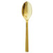 A close-up of a gold Oneida Chef's Table spoon with a long handle.