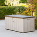 A tan and black Lifetime heavy-duty plastic storage box on a patio.