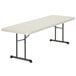 A white rectangular Lifetime plastic folding table with black legs.