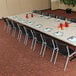 A Lifetime almond plastic folding table with chairs and candles on it.