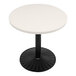 A white circular Art Marble Furniture table top on a black table base.