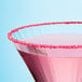 A pink cocktail with Adourne pink sanding sugar sprinkled on top.