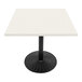 An Art Marble Furniture white quartz table top on a black table with black base.