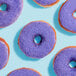 A group of donuts with purple frosting and Adourne lavender sanding sugar on top.