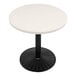 A white circular Art Marble Furniture quartz table top on a black table.