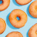 A group of donuts with Adourne orange sanding sugar on top.