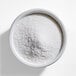 A bowl filled with fine white sanding sugar.