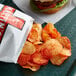 A Martin's bag of Red Hot Chips on a tray.