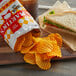 A sandwich and Martin's Bar-B-Q Waffle Cut Potato Chips on a plate.