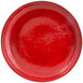 A red porcelain plate with black specks.