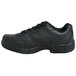 A black Genuine Grip men's athletic shoe with laces.